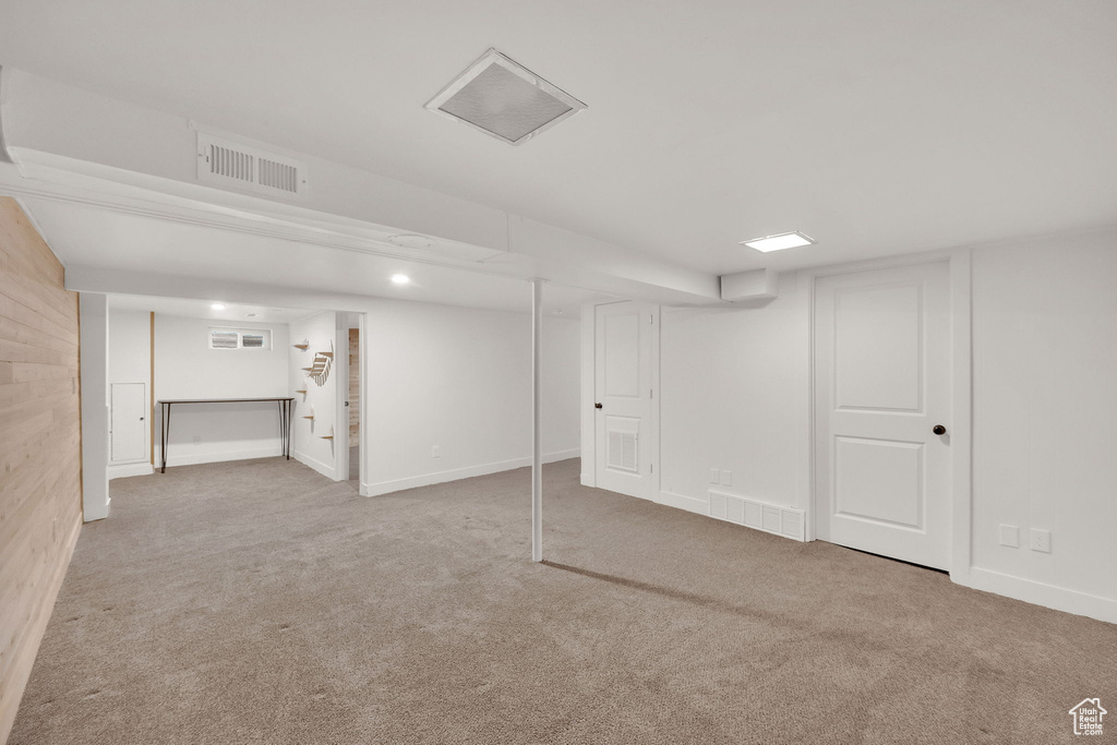 Finished below grade area featuring carpet flooring and baseboards