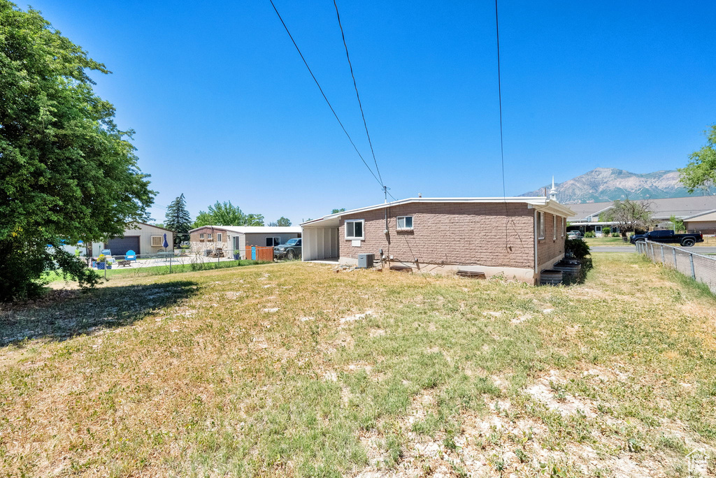 Rear view of house with brick siding and a mountain view