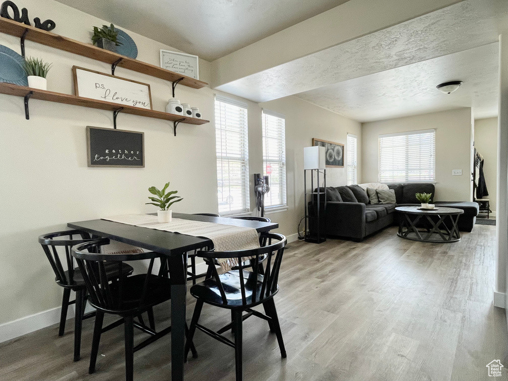 Dining space with baseboards and light wood-style floors
