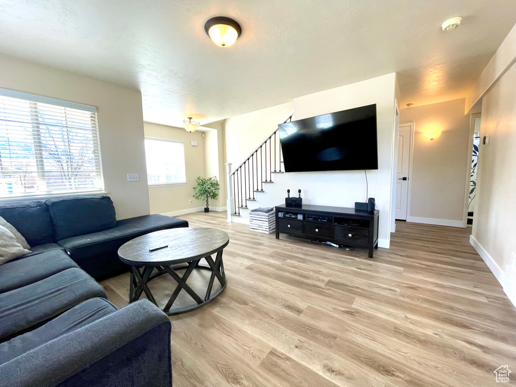 Living room featuring light wood-style floors and stairway