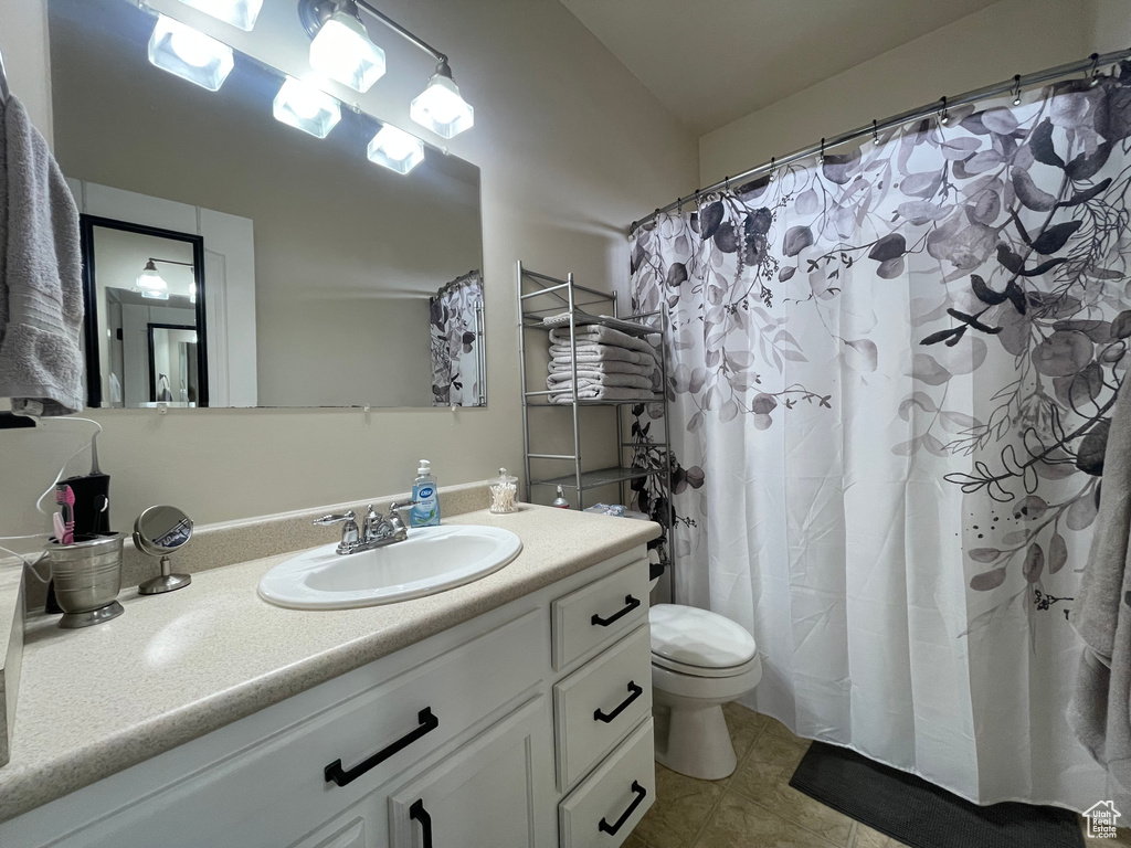 Full bath with vanity and tile patterned flooring