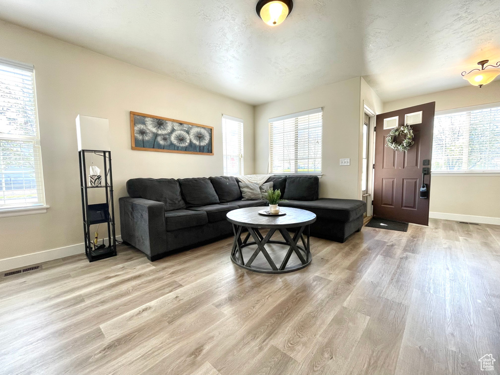 Living area featuring light wood-type flooring and baseboards
