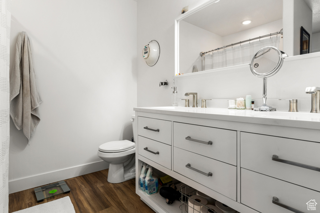 Full bathroom featuring vanity and wood finished floors