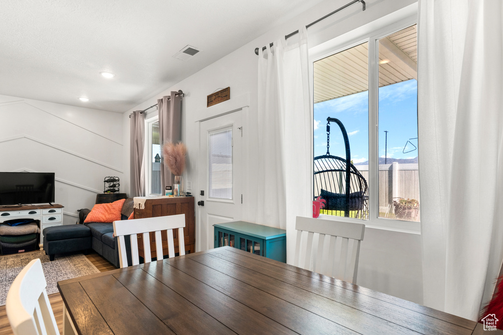 Dining area with healthy amount of natural light and wood finished floors