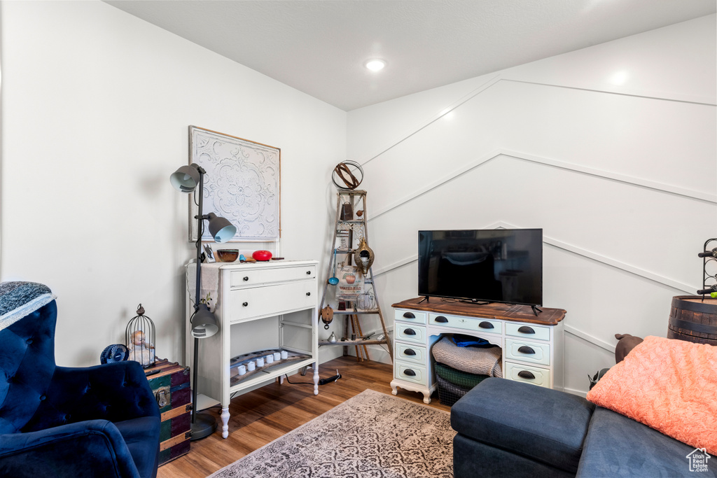 Living area featuring wood finished floors and recessed lighting