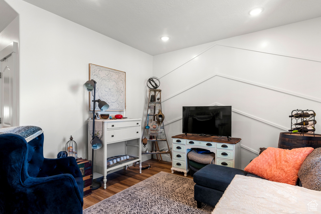 Living area with wood finished floors and recessed lighting