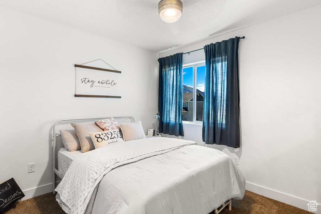 Carpeted bedroom featuring baseboards