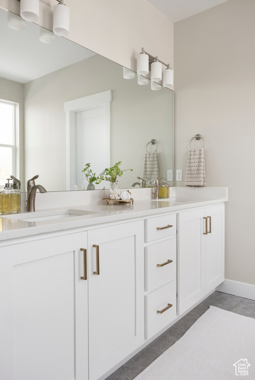 Full bathroom with double vanity and tile patterned floors