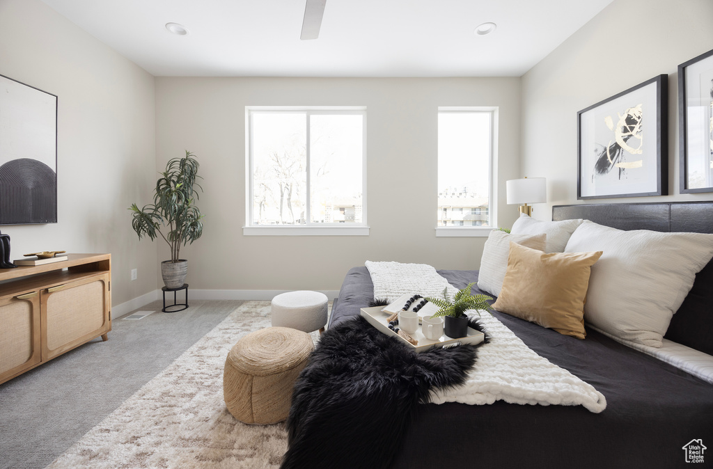 Carpeted bedroom featuring baseboards and ceiling fan