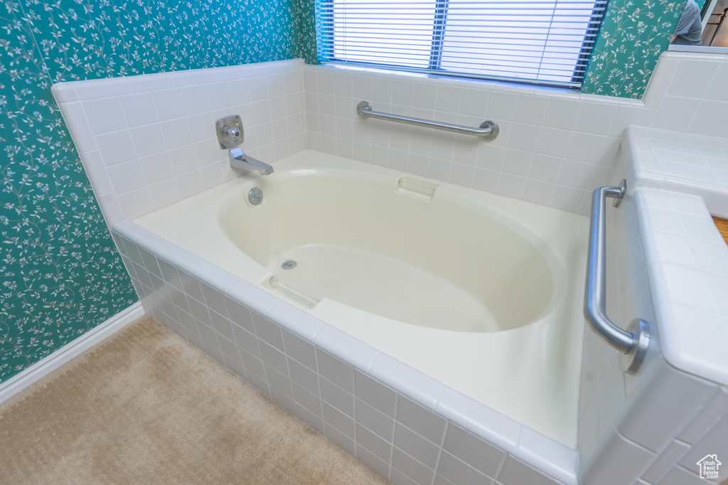 Full bathroom with wallpapered walls and a garden tub
