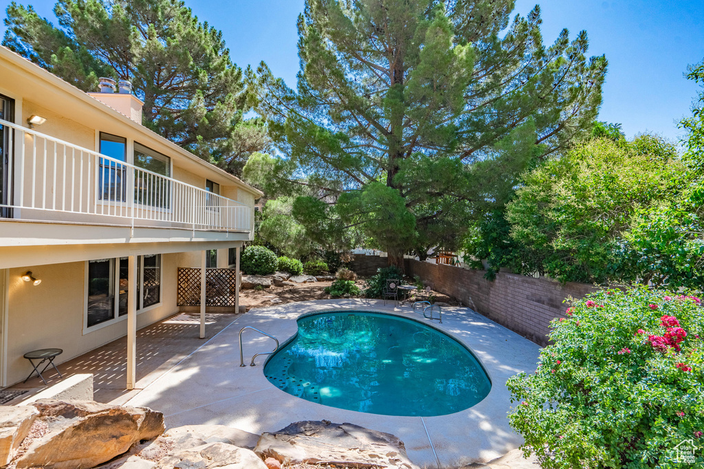 View of swimming pool featuring a fenced backyard and a patio area