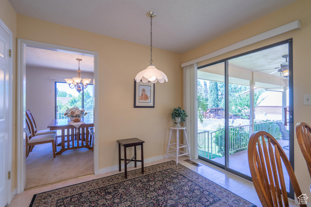 Dining room with a chandelier and a ceiling fan
