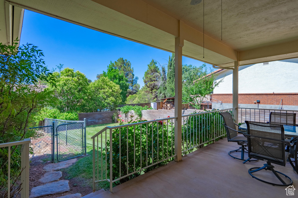 View of patio with a gate and outdoor dining area
