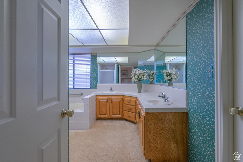 Bathroom featuring double vanity and a bath