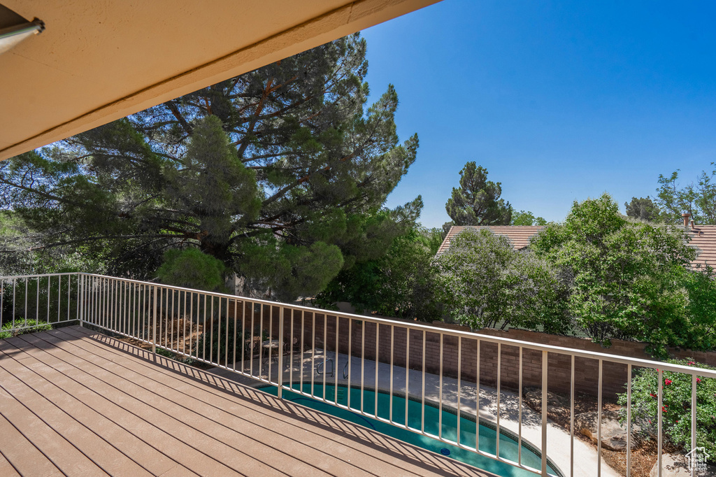 Wooden deck featuring a fenced backyard and a hot tub