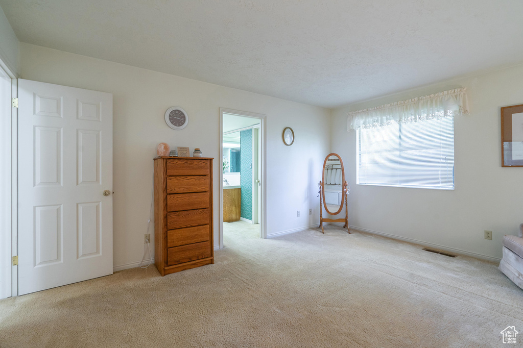 Bedroom featuring carpet and multiple windows
