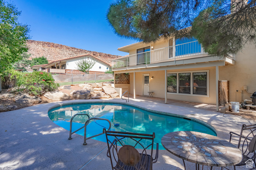 View of pool featuring a patio and a mountain view