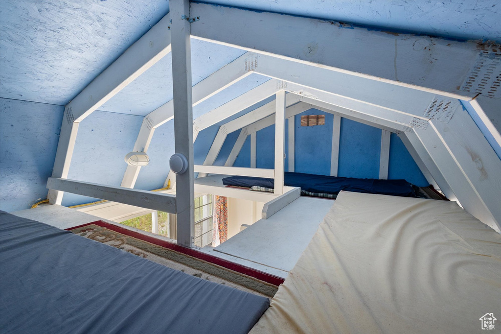Bedroom featuring lofted ceiling
