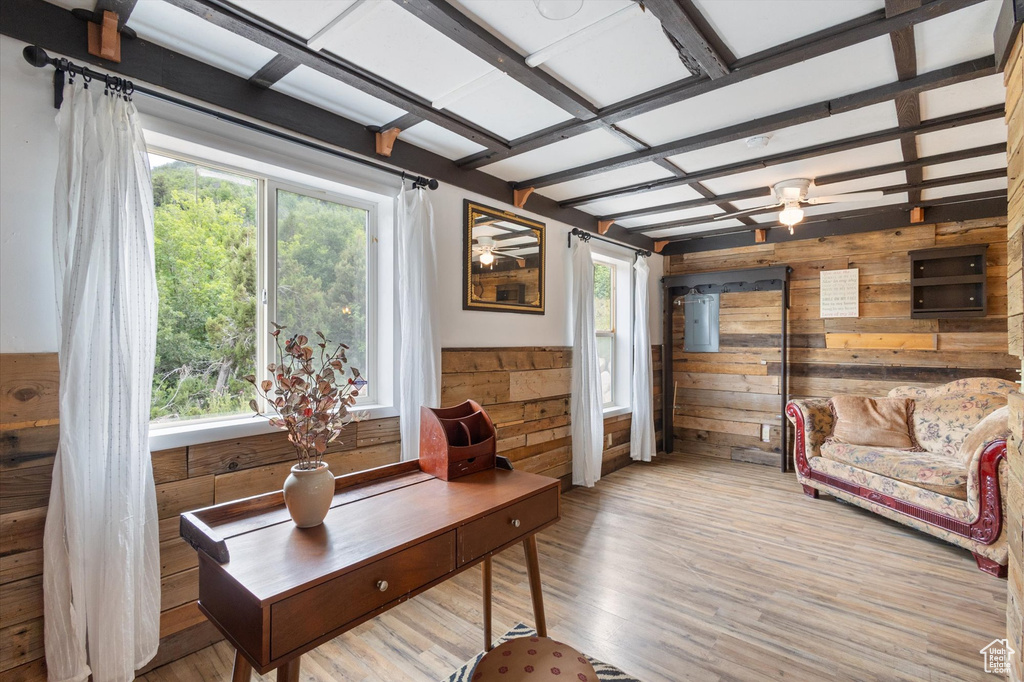Home office featuring wood walls and wood finished floors