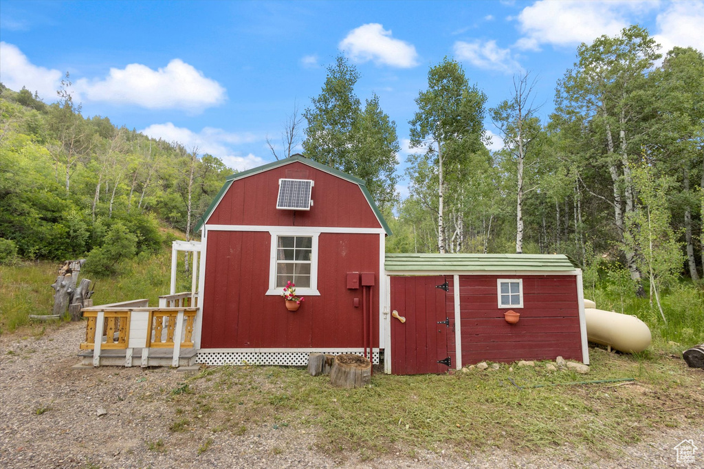 View of shed featuring a view of trees