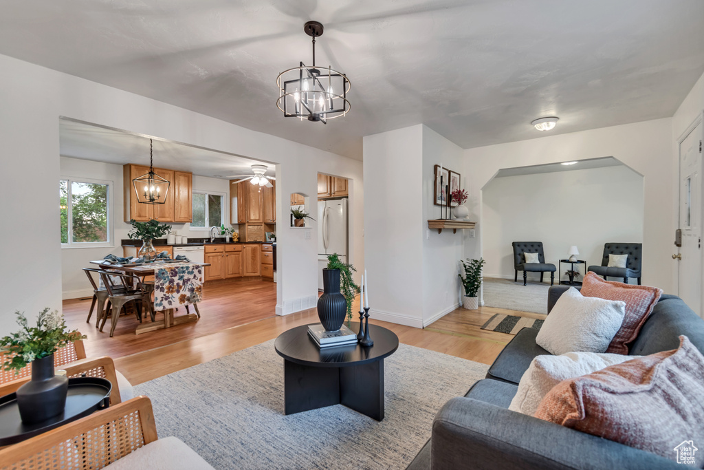 Living room with a chandelier and light wood-style flooring