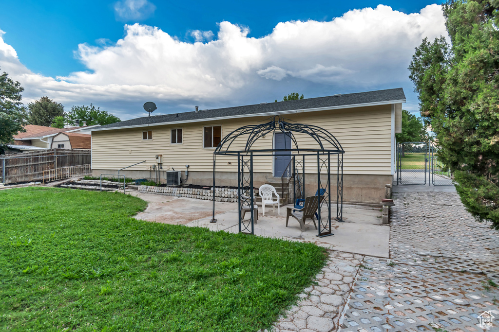 Rear view of property featuring a gate and a patio