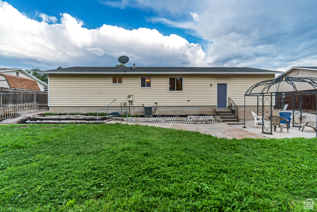 Back of property featuring entry steps, a patio area, and a gazebo