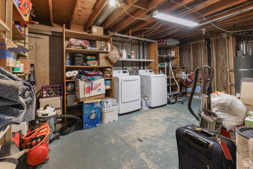 Unfinished below grade area with washer and clothes dryer