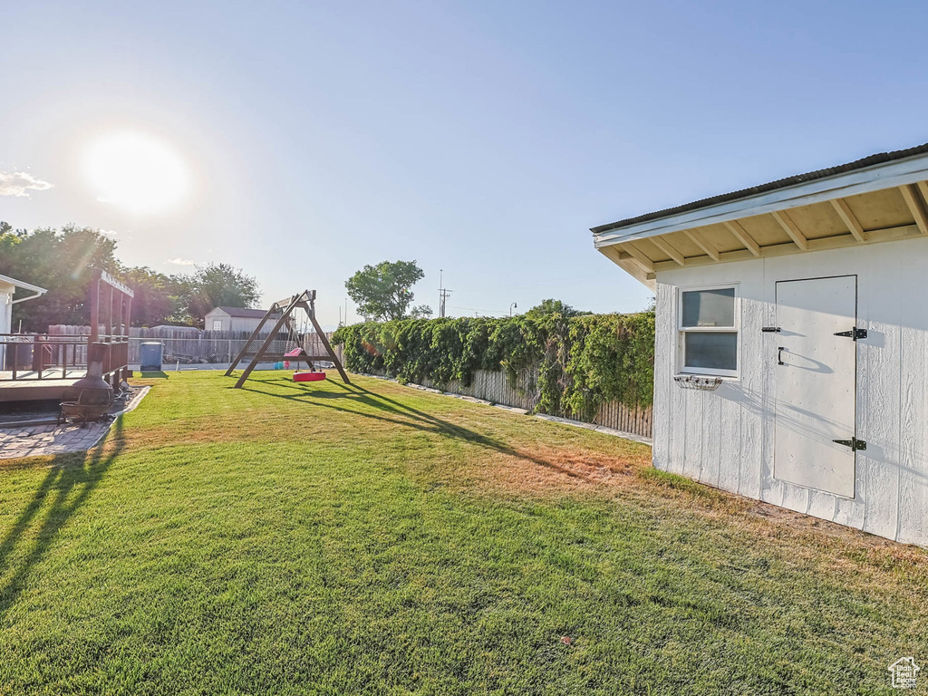 View of yard with a storage shed and a playground
