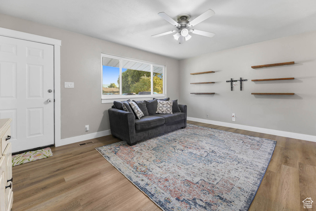 Living room with ceiling fan and wood finished floors