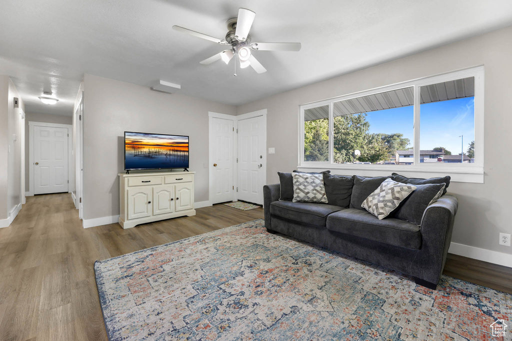 Living room featuring wood finished floors and ceiling fan