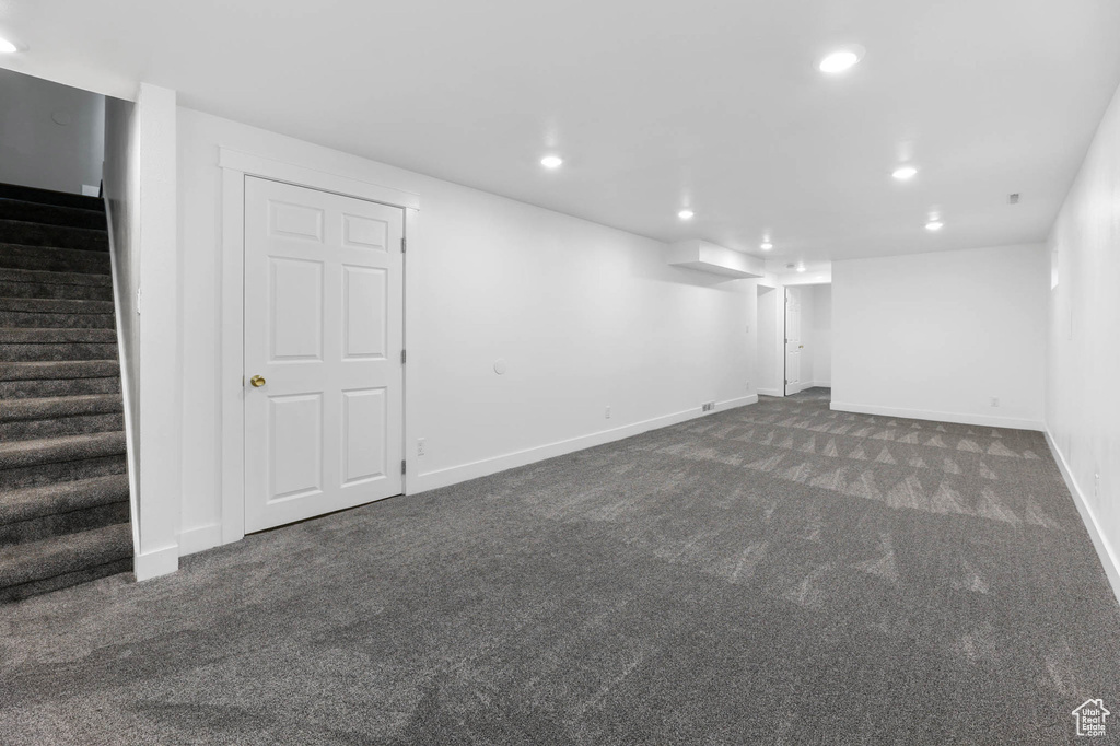 Finished below grade area featuring carpet flooring, stairway, and recessed lighting