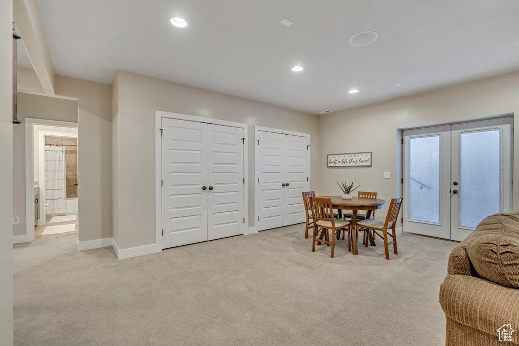 Dining room featuring french doors, light carpet, and recessed lighting