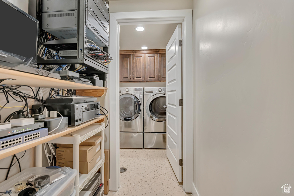 Laundry area with washing machine and clothes dryer, cabinet space, and recessed lighting