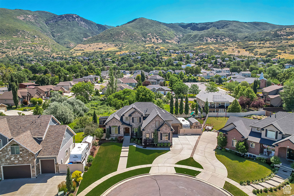 Aerial perspective of suburban area with a mountainous background