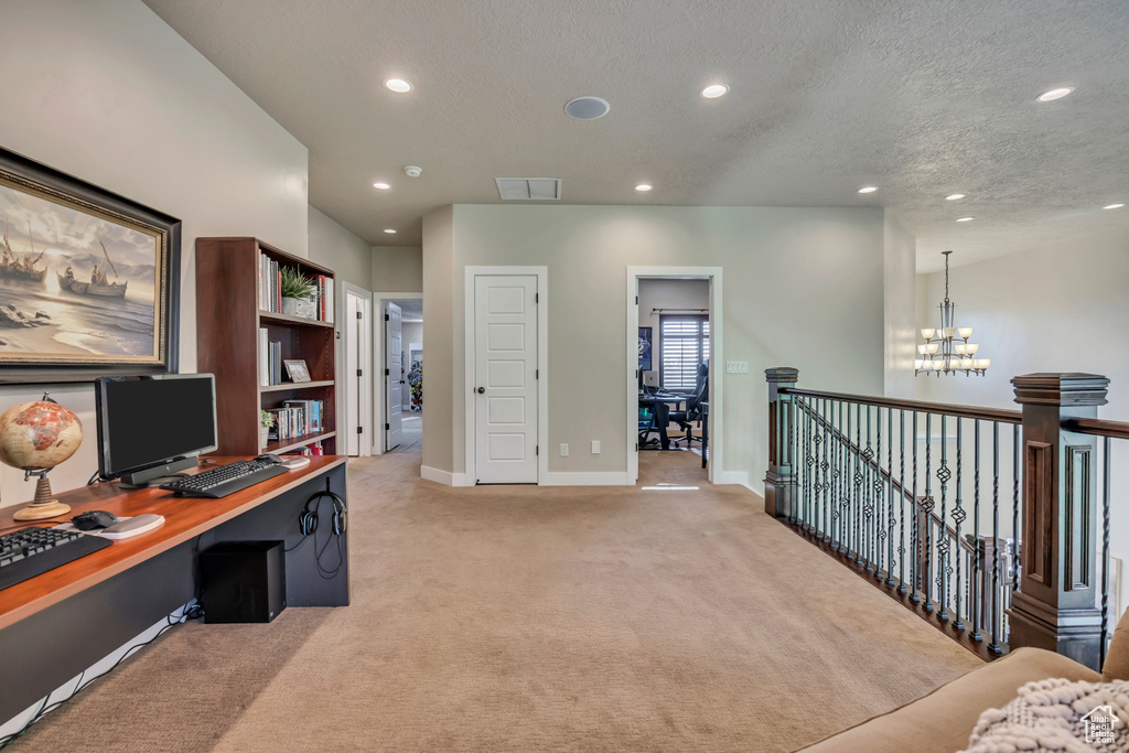Office space featuring recessed lighting, light carpet, a textured ceiling, and a chandelier
