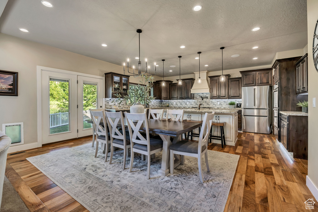 Dining room featuring recessed lighting, a chandelier, and dark wood-style floors