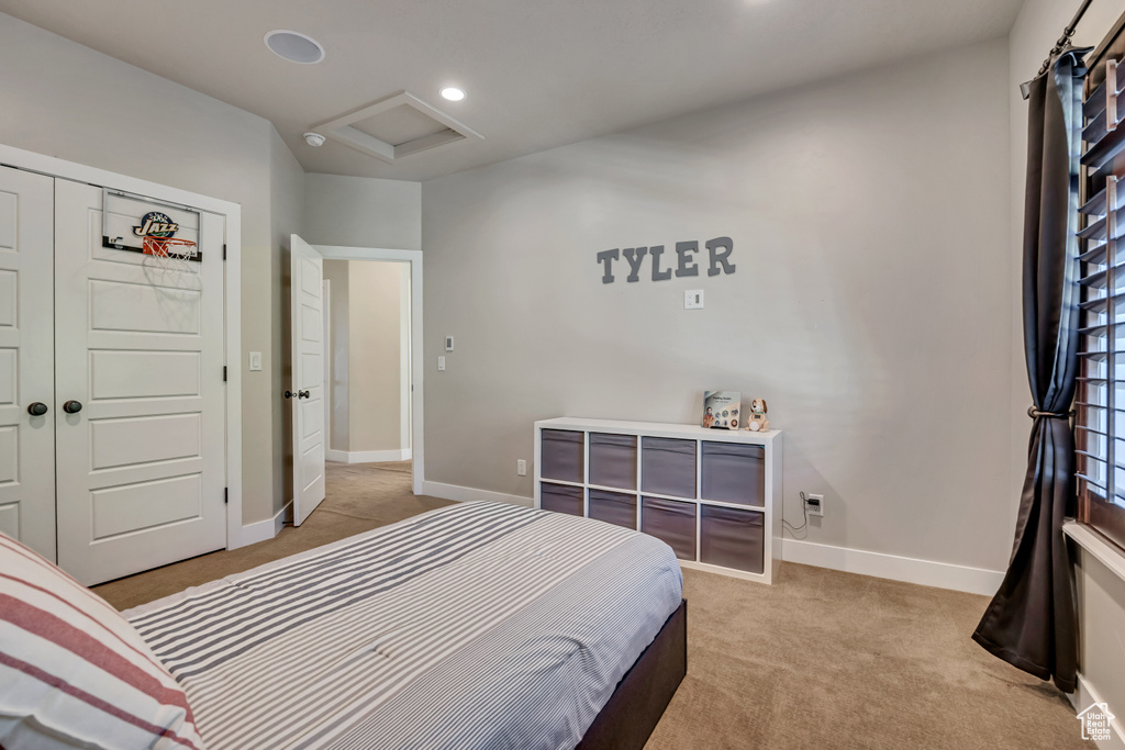 Bedroom featuring attic access, light carpet, and recessed lighting