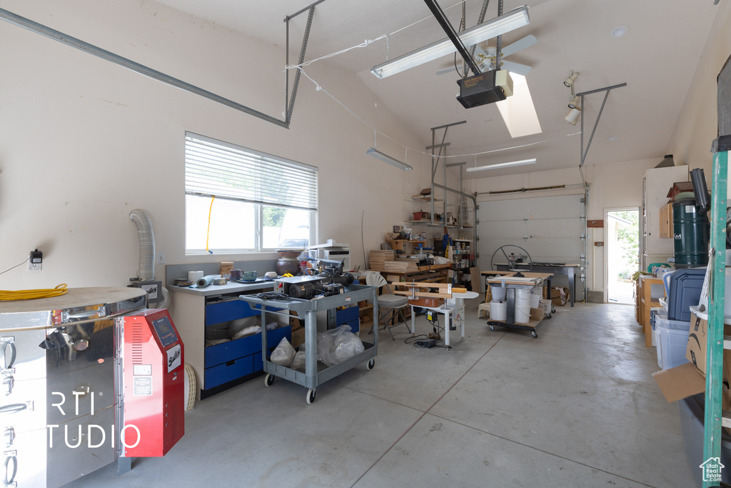 Garage featuring a garage door opener and a workshop area