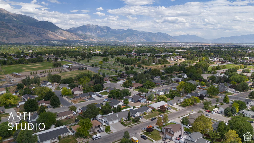 Aerial view of property and surrounding area with nearby suburban area