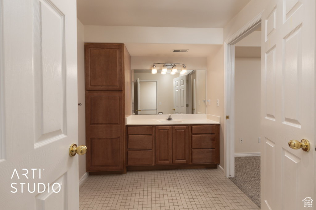 Bathroom featuring vanity and baseboards