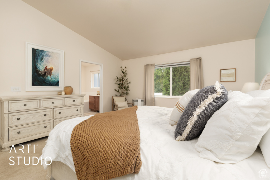 Carpeted bedroom with lofted ceiling and ensuite bathroom