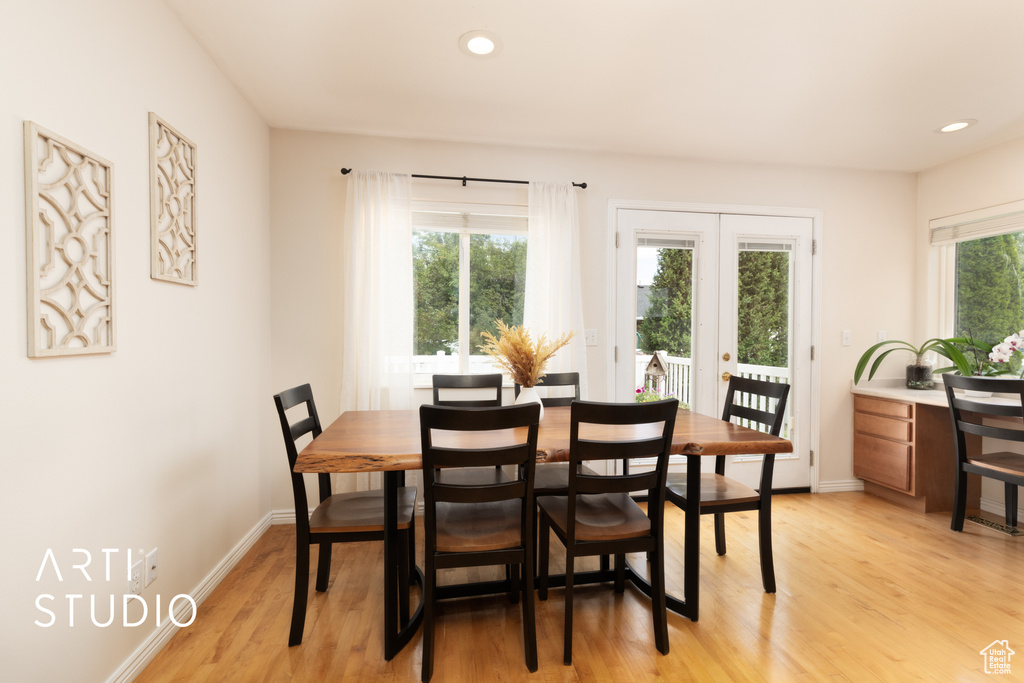 Dining space with light wood-style floors, french doors, and recessed lighting