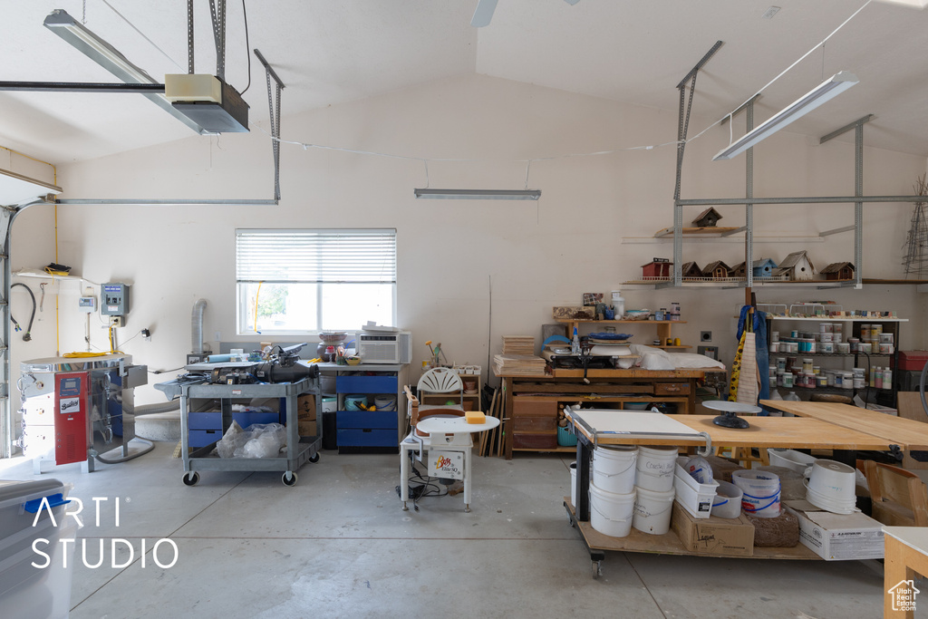 Garage with a workshop area and a garage door opener