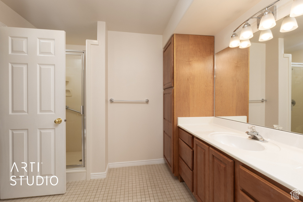 Bathroom with a stall shower and vanity