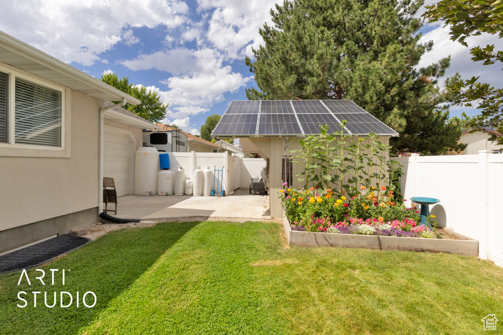 Fenced backyard featuring a patio and an outdoor structure
