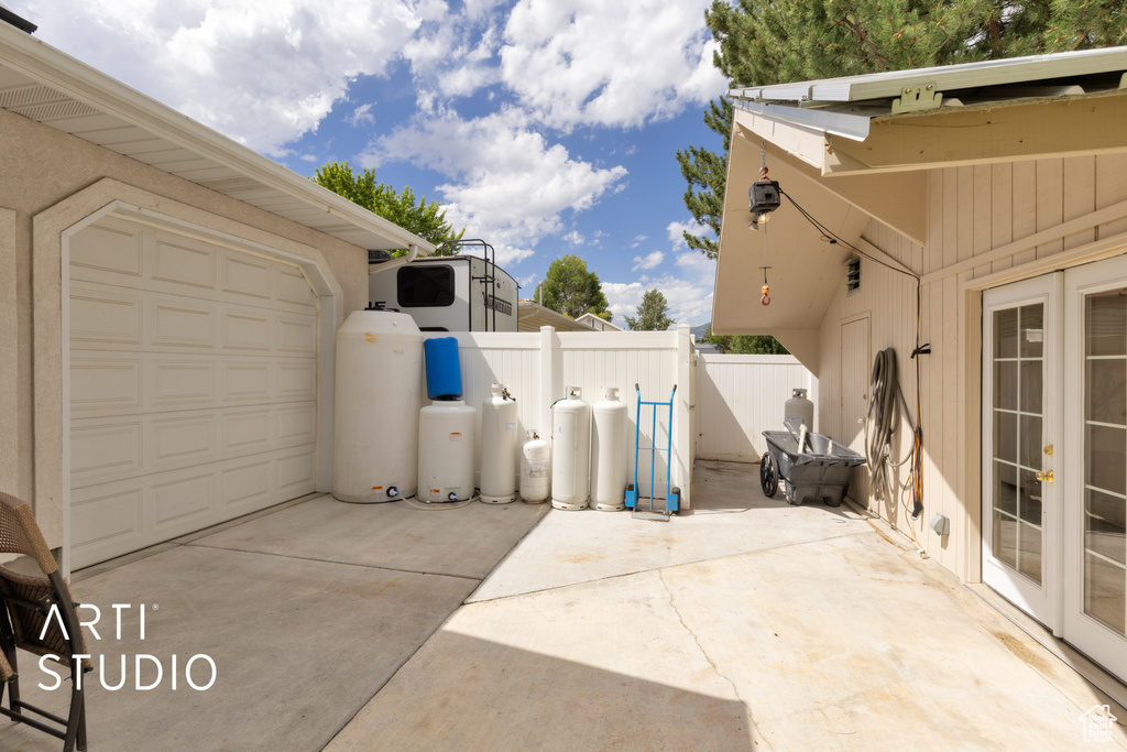 View of patio featuring concrete driveway