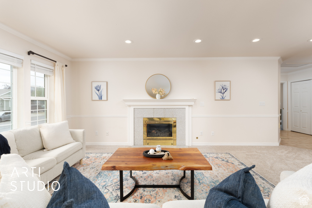 Carpeted living room with crown molding, recessed lighting, and a tiled fireplace