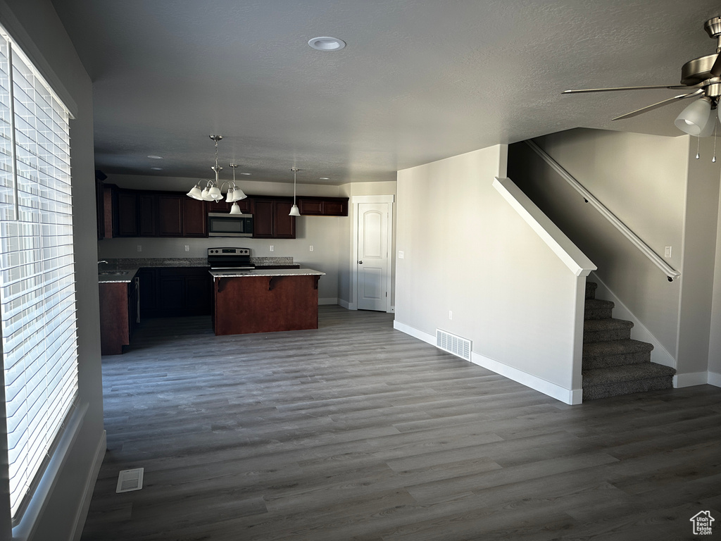 Kitchen featuring stainless steel appliances, open floor plan, ceiling fan, dark wood-style flooring, and recessed lighting