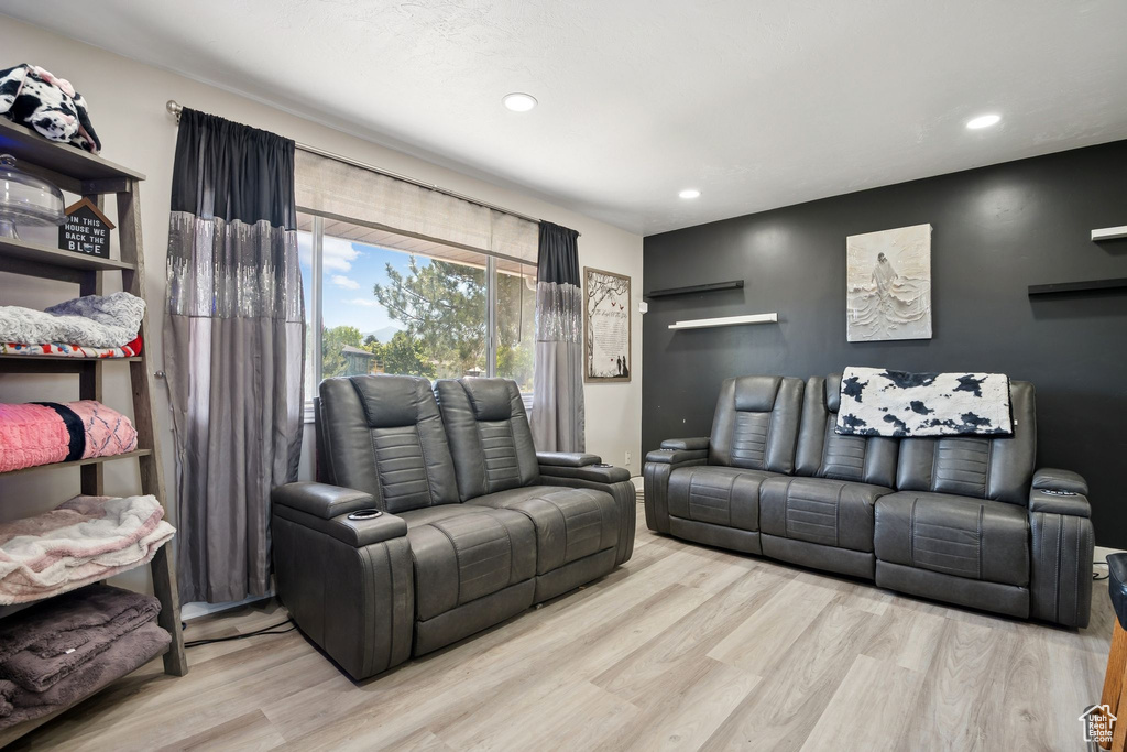 Living room with wood finished floors and recessed lighting